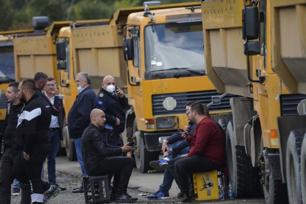 Truck drivers sit near the Jarinje border crossing on September 20, 2021. -