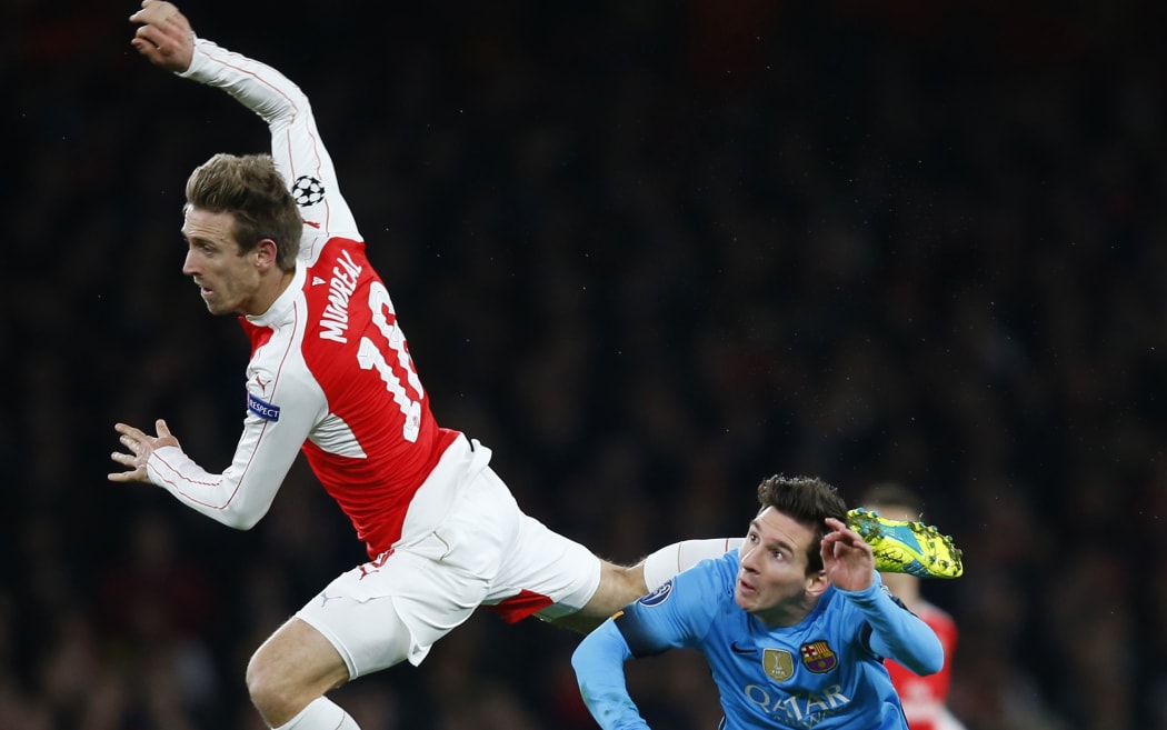 Nacho Monreal of Arsenal sails above Lionel Messi of FC Barcelona, Champions League 2016.