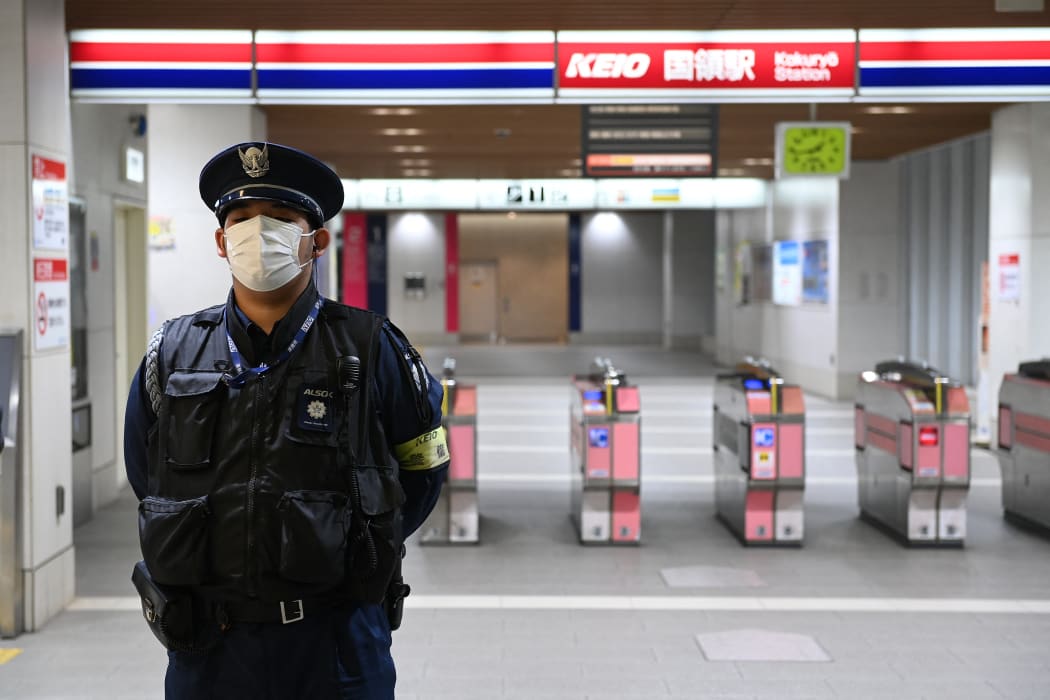 Officials are seen at the entrance of the train station Kokuryo of the Keio line where a man injured several people on the train, using fire and knife, was arrested on suspicion of attempted murder on the night of Halloween on November 1, 2021, in Tokyo, Japan.