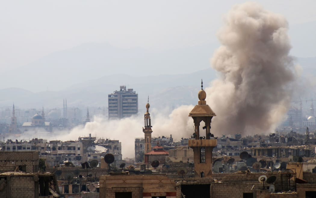 Smoke billows following a reported air strike in the rebel-held parts of the Jobar district, on the eastern outskirts of the Syrian capital Damascus.