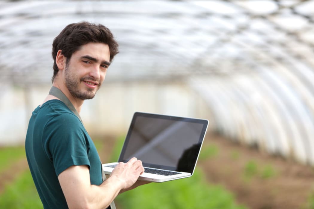 young farmer with laptop
