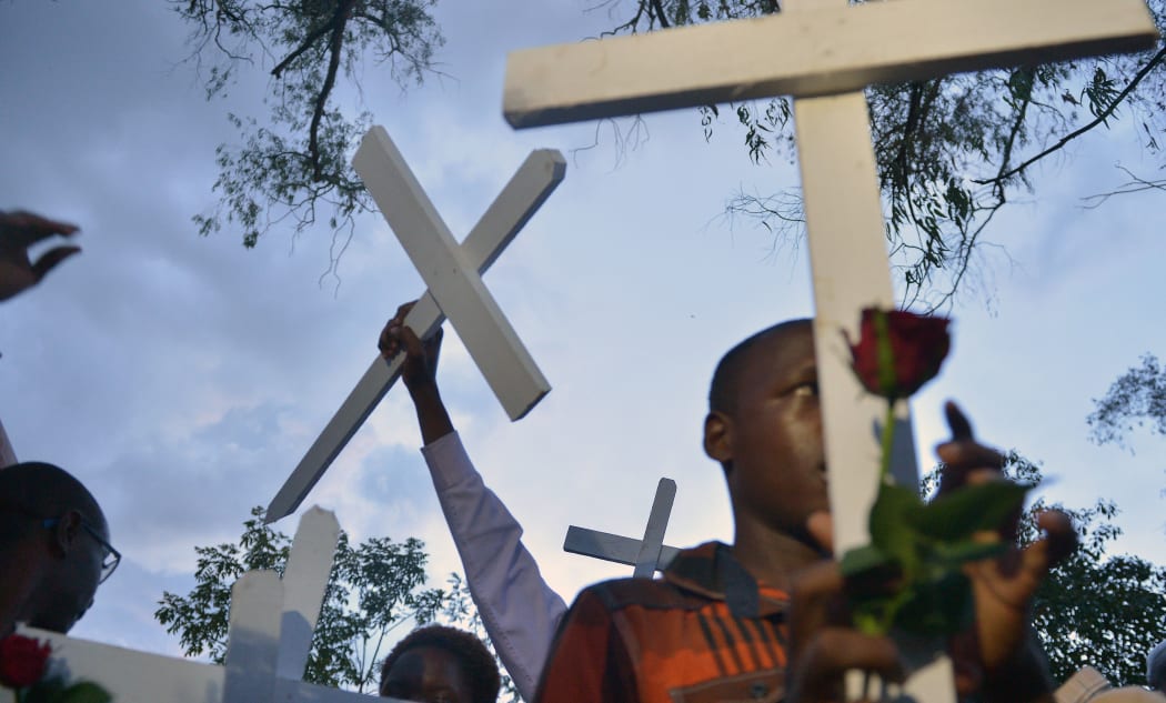 People carry wooden crosses to Freedom Corner in Nairobi in April during a gathering for the victims of an attack claimed by Somalia's Al-Qaeda-linked al-Shabaab insurgents on a university campus in Garissa, Kenya in which 148 people were killed. AFP PHOTO / TONY KARUMBA