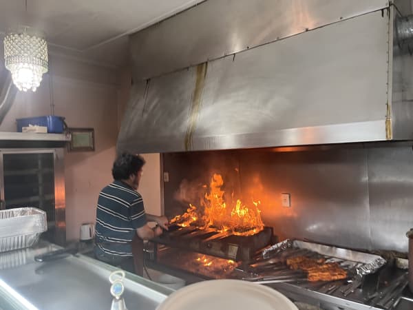 Afghan owner Abdul gets the grill ablaze.
