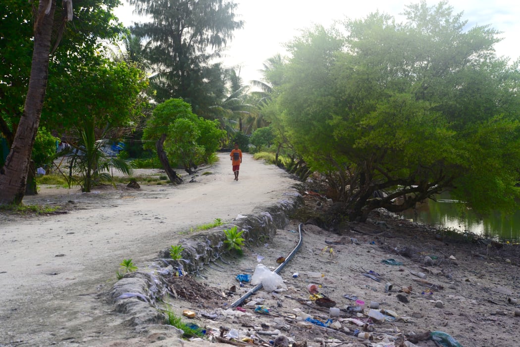 child walks along  unsealed road