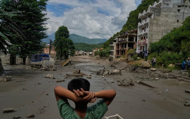 A boy looks at the devastation caused by flash flooding along the Trishuli River in Nepal's Nuwakot district on Wednesday.