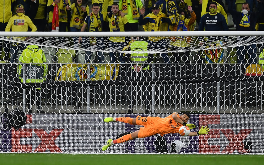 Villarreal's Argentine goalkeeper Geronimo Rulli deflects a shot by Manchester United goalkeeper David de Gea in the penalty shoot-out during the UEFA Europa League final football match at the Gdansk Stadium in Poland on May 26, 2021.