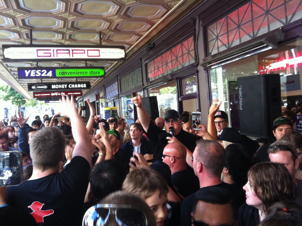 Kim Dotcom promotes his new website on Queen Street in Auckland.