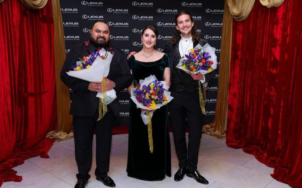 Lexus SongQuest 2024 winners holding their flowers. (L to R) Manase Latu, tenor, 2nd Place;  Katie Trigg, mezzo soprano, 1st Place; Austin Haynes, counter tenor, 3rd Place.