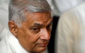 (FILES) In this file photo taken on May 12, 2022, Sri Lanka's new prime minister Ranil Wickremesinghe visits a Buddhist temple after his swearing in ceremony in Colombo. - The 73-year-old Wickremesinghe will automatically become acting president in the event of Gotabaya Rajapaksa's resignation, but has himself announced his willingness to step down if consensus is reached on forming a unity government. (Photo by Ishara S. KODIKARA / AFP)