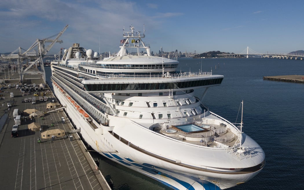 Medical personnel help load passengers onto buses as they are disembarked from the Grand Princess cruise ship at the Port of Oakland in Oakland, California on March 10, 2020. The first passengers were taken ashore from a coronavirus-hit cruise ship that docked at California's port of Oakland on March 9, 2020, with the infected "being dealt with in proper isolation," said US Vice President Mike Pence. The Grand Princess arrived in the San Francisco Bay after days stranded at sea with 21 confirmed coronavirus infections among more than 3,500 passengers and crew.
