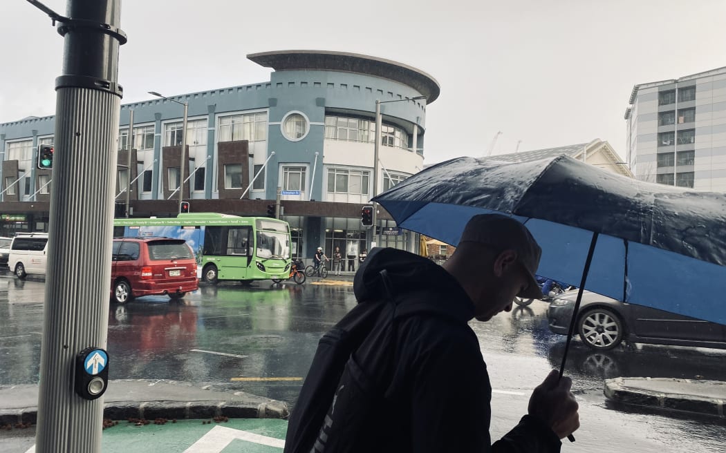 A pedestrian in central Auckland after strong winds battered the region.