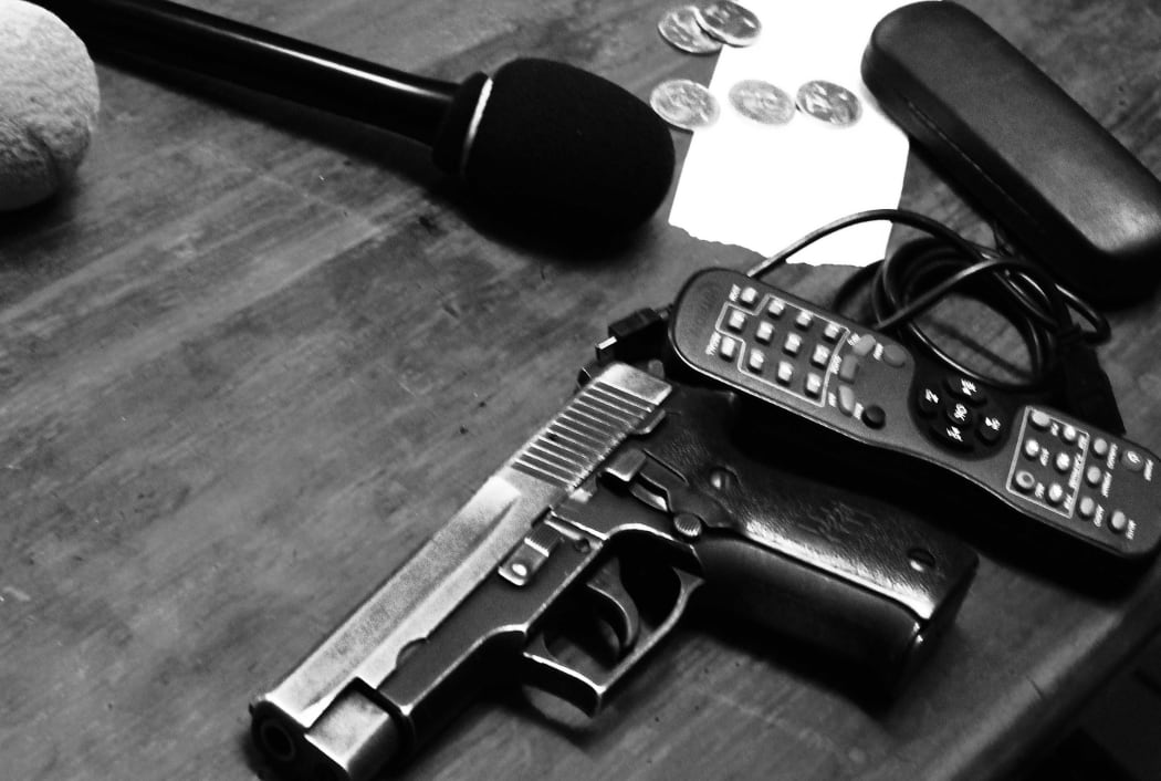 Photo taken by Johnny  during an interview with a local MP who placed his gun on the table as they spoke.