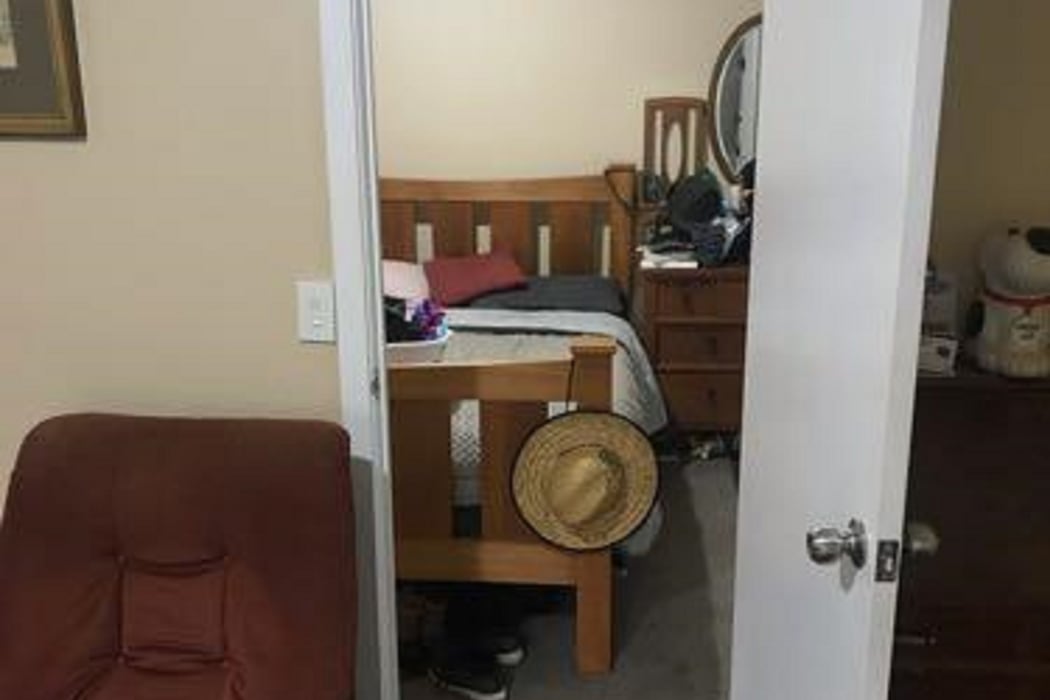 The smaller room in the shed was being used as a bedroom.