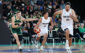Tall Black Flynn Cameron brings the ball down court against Australia.