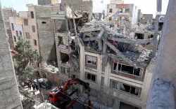 Firefighters look for victims and inspect damages at a residential building in southern Tehran on March 27, 2026, nearly a month into the Middle East war.