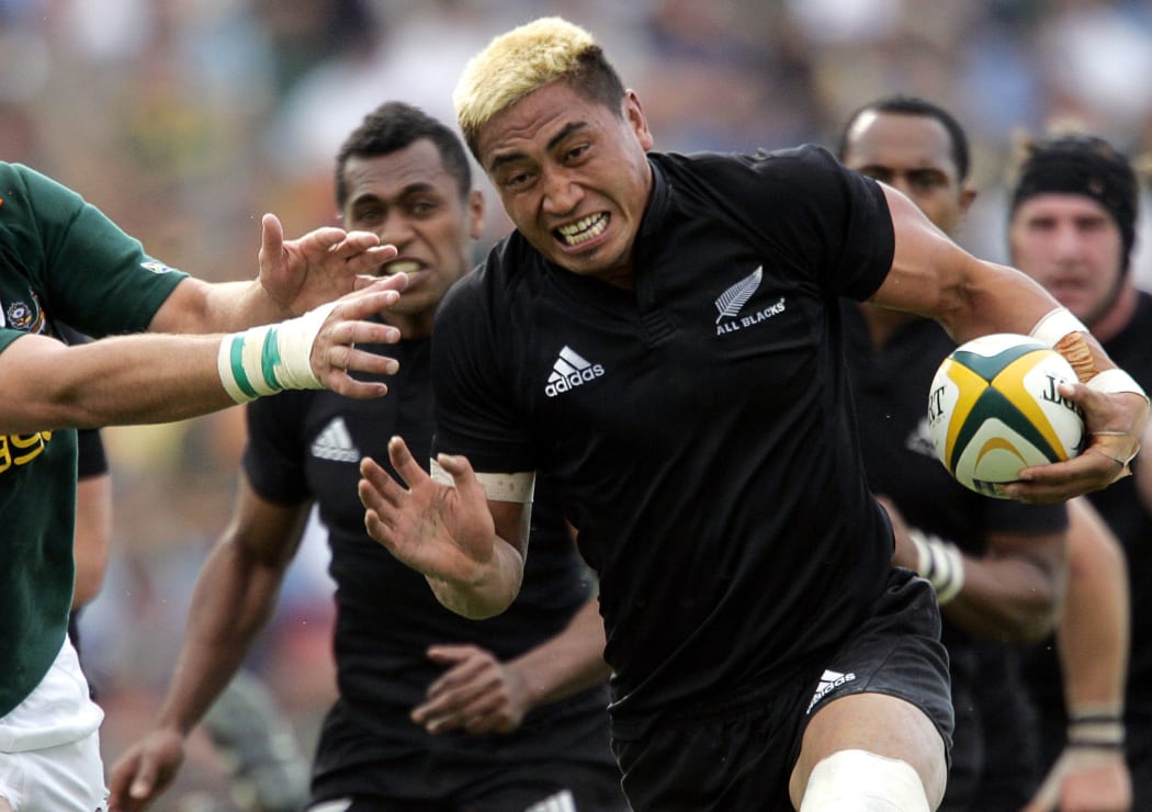 Jerry Collins fends off the tackle during a match against South Africa in 2006.