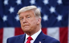 US President Donald Trump looks on after delivering an update on "Operation Warp Speed" in the Rose Garden of the White House in Washington, DC on November 13, 2020.