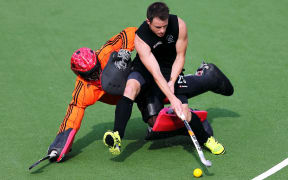 Shea Mcaleese of New Zealand goes around Andrey Rocke goal keep of Trinidad and Tobago Glasgow 2014.