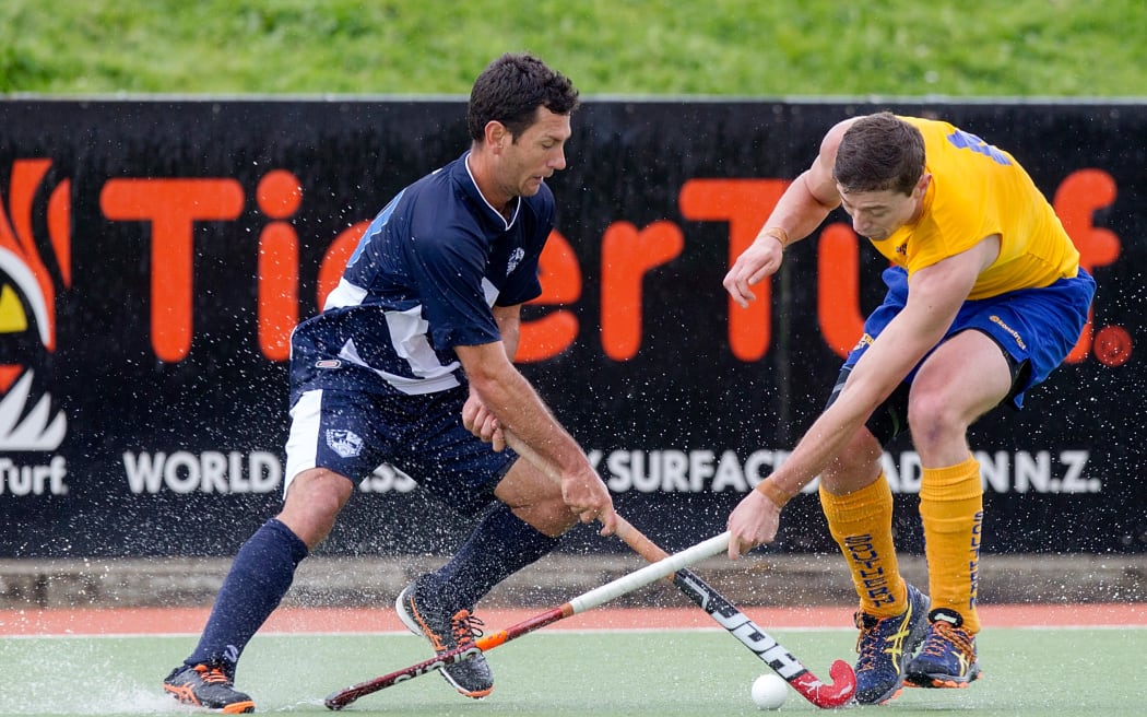Auckland`s Jamie Dwyer is challenged by Southern`s Callum Bailey in the Auckland v Southern Men`s semi-final match, Ford National Hockey League, North Harbour Hockey Stadium, Auckland, New Zealand,Saturday, September 13, 2014.