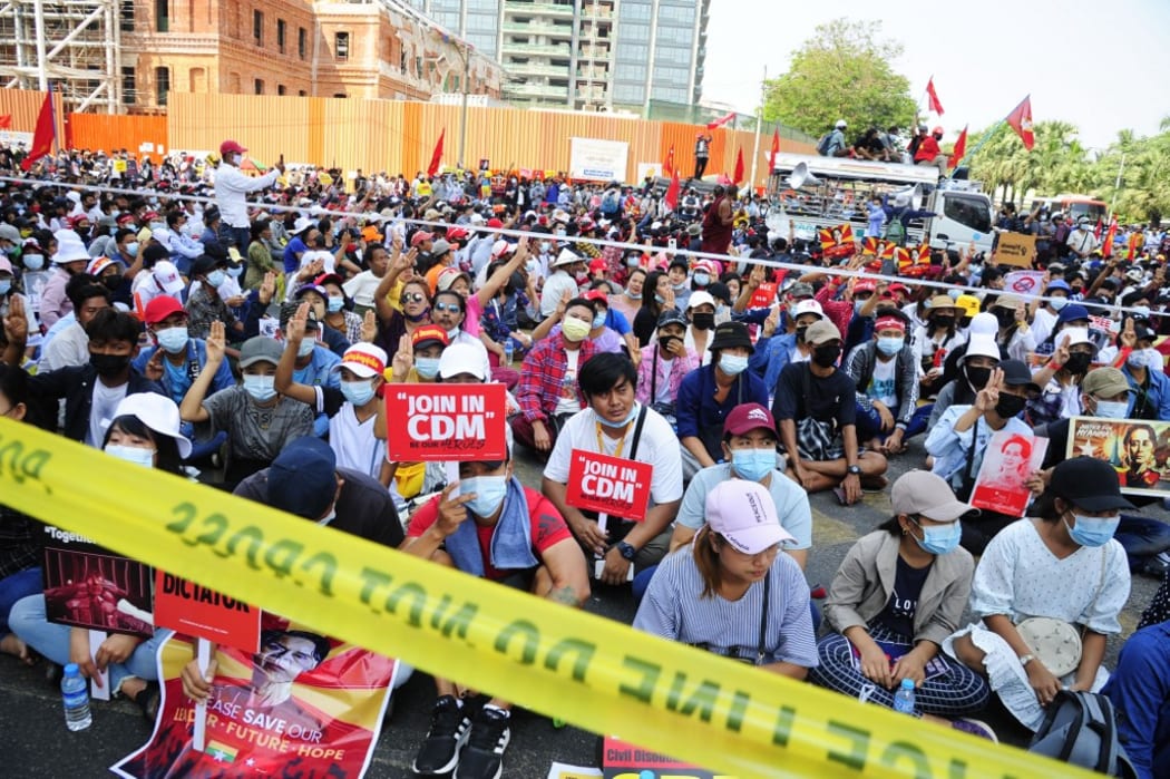 YANGON, MYANMAR - FEBRUARY 20: Anti-coup protesters hold placards as they protest against the military coup Saturday, February 20, 2021, in Yangon, Myanmar. Stringer / Anadolu Agency