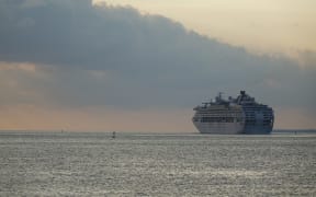 A cruise ship departs Port Vila harbour in Vanuatu.