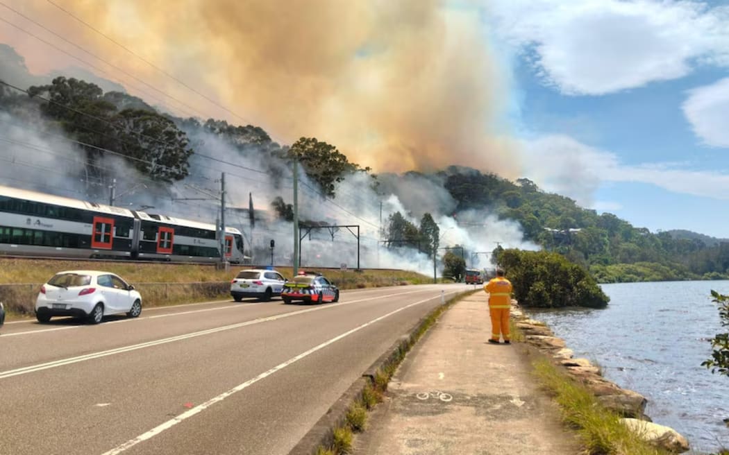 Trains have stopped running on the Central Coast and Newcastle line after a fire broke out on Nimbin Road at Koolewong. (Supplied: Central Coast Council)