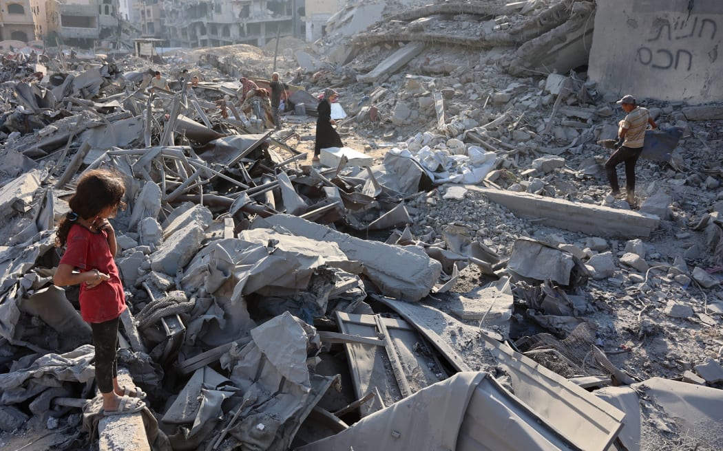 Palestinians inspect the damage after an overnight strike on the Sheikh Radwan Health Centre run by the United Nations Relief and Works Agency for Palestine Refugees (UNRWA) in the north of Gaza City on August 6, 2025. Gaza's civil defence agency said 68 people were killed by Israeli gunfire and air strikes on August 5, including 56 who were waiting near aid distribution sites inside the Palestinian territory.