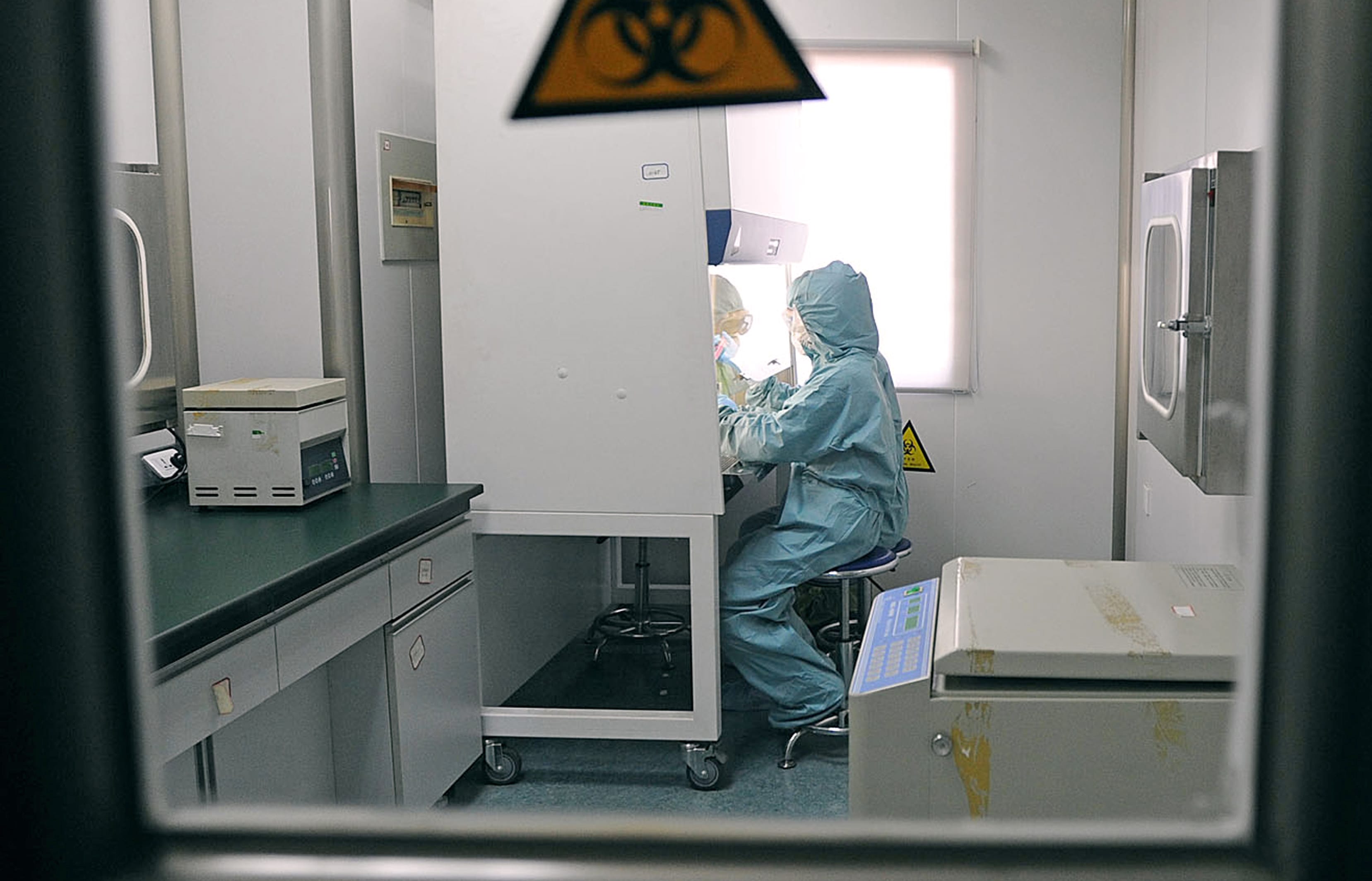 A Chinese medic testing for the swine flu H1N1 virus at a hospital in Hefei, China, in 2009.