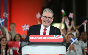 Britain's Labour Party leader Keir Starmer delivers a speech during a victory rally at the Tate Modern in London early on July 5, 2024. The UK's Labour Party swept to power after winning the country's general election, crossing the 326-seat threshold for a working majority in the House of Commons. (Photo by JUSTIN TALLIS / AFP)