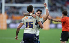 Moana Pasifika players celebrate after beating the Highlanders.