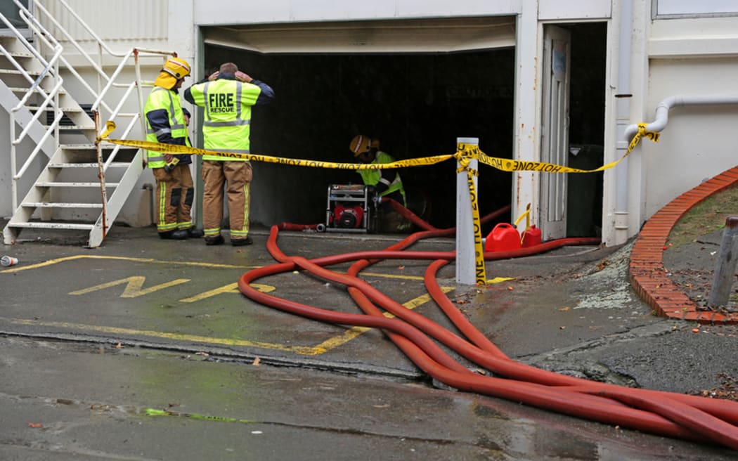 Firefighters pumping out a flooded carpark in Newtown, Wellington.