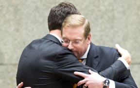 Ard van der Steur (right) hugs Prime Minister Mark Rutte after he resigns.