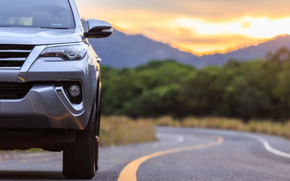 An SUV vehicle on a country road.