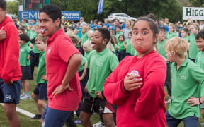 Students perform a mass haka in an attempt to break the Guinness World Record for the largest haka at Memorial Park in Masterton on November 2, 2016. Some seven thousand schoolchildren from the Wairarapa area took part in the attempt to break the record, which is currently held by participants from France. (Photo by Marty Melville / AFP)