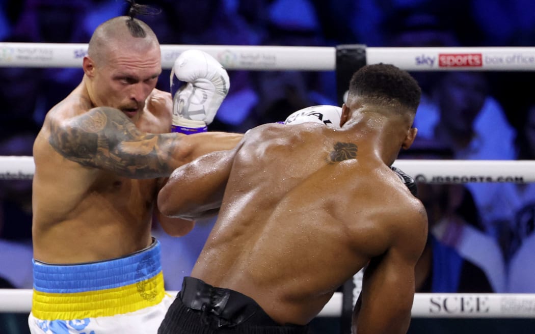 Ukraine's Oleksandr Usyk and Britain's Anthony Joshua compete during the heavyweight boxing rematch for the WBA, WBO, IBO and IBF titles, in Jeddah, 2022.