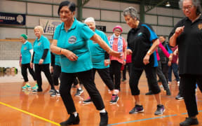 Kaumatua doing line dancing and practicing sparring
