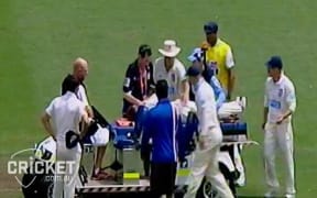 Phil Hughes being taken from the Sydney Cricket Ground on a stretcher.