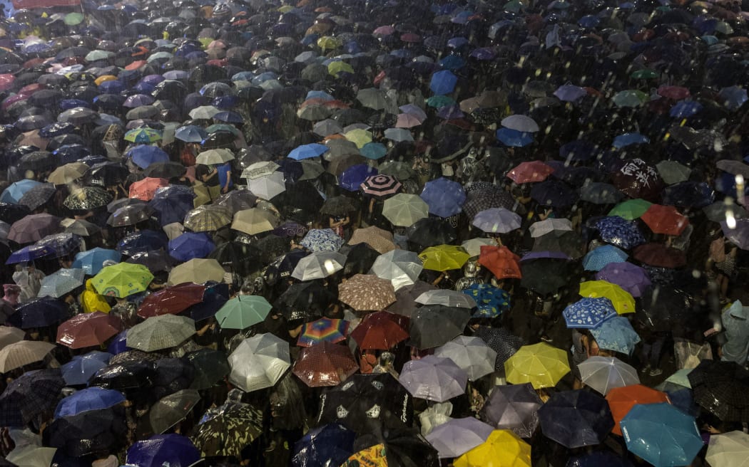 Hong Kong pro-democracy protesters shelter from the rain.