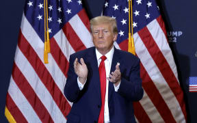 Former US President and 2024 presidential hopeful Donald Trump applauds at the end of a campaign event in Waterloo, Iowa, on December 19, 2023. An appeals court in Colorado on December 19, 2023 ruled Donald Trump cannot appear on the state's presidential primary ballot because of his involvement in the attack on the Capitol in January 2021. (Photo by KAMIL KRZACZYNSKI / AFP)