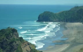 A man has spent the night stranded at Piha Beach.
