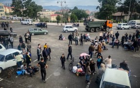 Ethnic Armenians wait to be evacuated from Stepanakert on 26 September, 2023. Armenia on September 26 said 28,120 refugees have so far arrived from Nagorno-Karabakh, a majority ethnic Armenian breakaway enclave defeated in a lightning offensive by Azerbaijan last week.