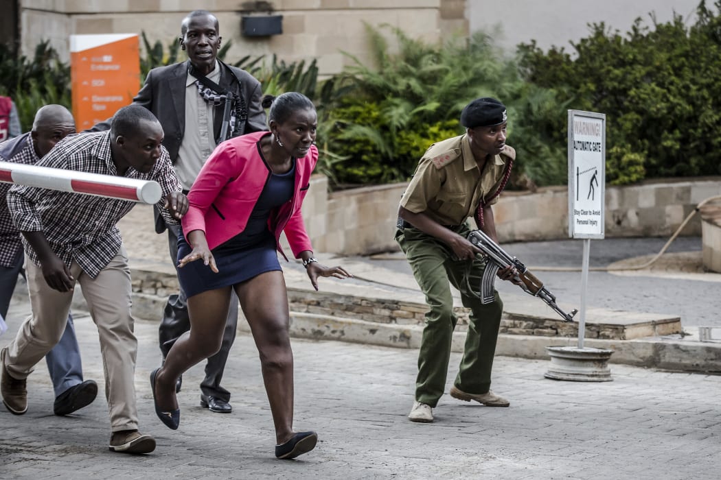 People leave the scene of an explosion at a hotel complex in Nairobi's Westlands suburb on January 15, 2019, in Kenya.