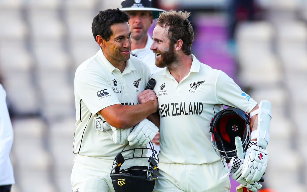 Ross Taylor (left) and Kane Williamson leave the pitch after New Zealand had won the ICC World Test Championship Final, 2021.