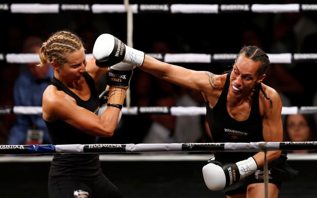 Lauryn Eagle cops a punch from Daniella Smith at the Woodstock Honey Fight For Life, Trusts Stadium Henderson, on 15 December, 2012.