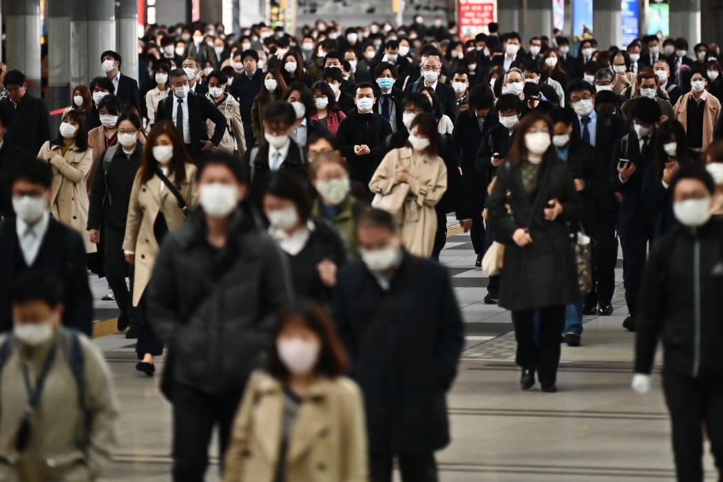 People commute to work despite a state of emergency in Japan at Shinagawa station in Tokyo on April 16, 2020.