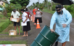 People lining up to get food supplied from Save the Children on the main island Viti Levu.