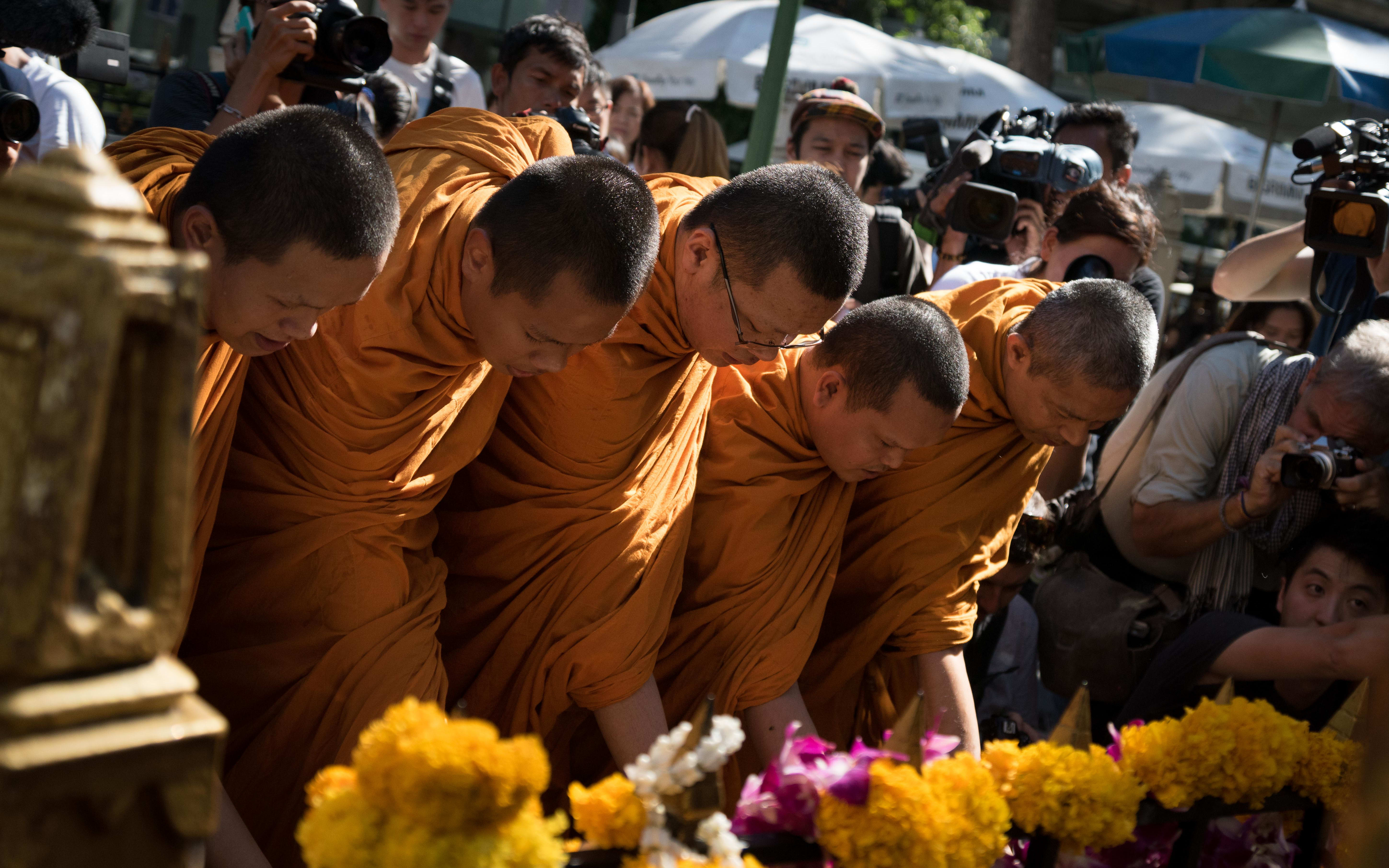 Monks make offerings at the re-opened Erawan Shrine on 19 August 2015.