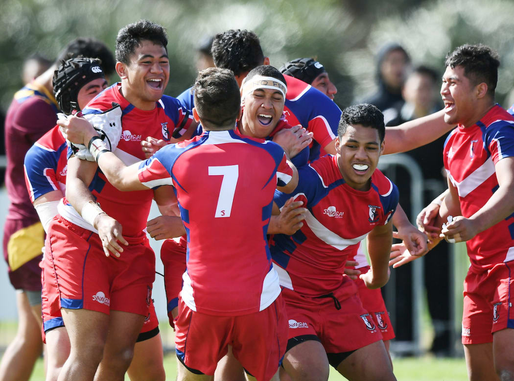 Kelston Boys High School players celebrate winning the 2018 premier grade final.