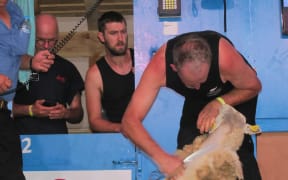 Blades team winners Allan Oldfield, centre, watching Tony Dobbs shearing, at the World Shearing and Woolhandling Championships in France.