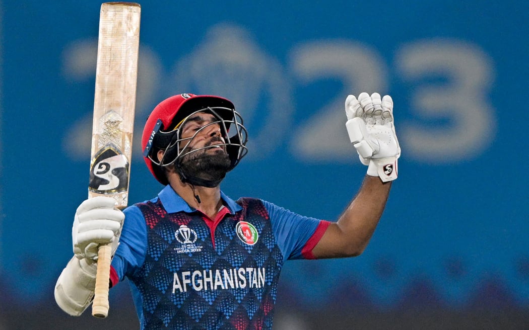 Afghanistan's captain Hashmatullah Shahidi celebrates after scoring a half-century (50 runs) during the 2023 ICC Men's Cricket World Cup one-day international (ODI) match between Netherlands and Afghanistan at the Ekana Cricket Stadium in Lucknow on November 3, 2023. (Photo by Arun SANKAR / AFP) / -- IMAGE RESTRICTED TO EDITORIAL USE - STRICTLY NO COMMERCIAL USE --